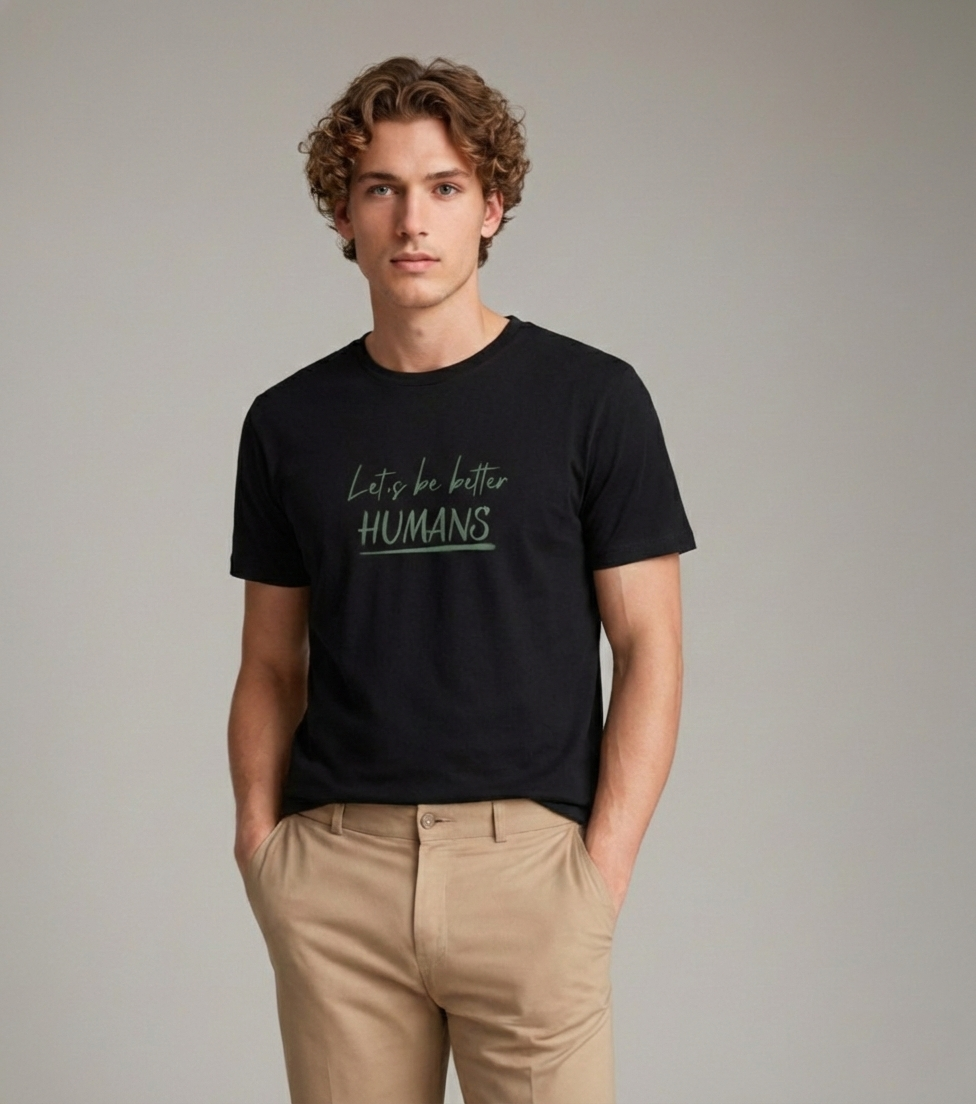 Model wearing Velmora Let's Be Better Humans black motivational minimal streetwear t-shirt front design 