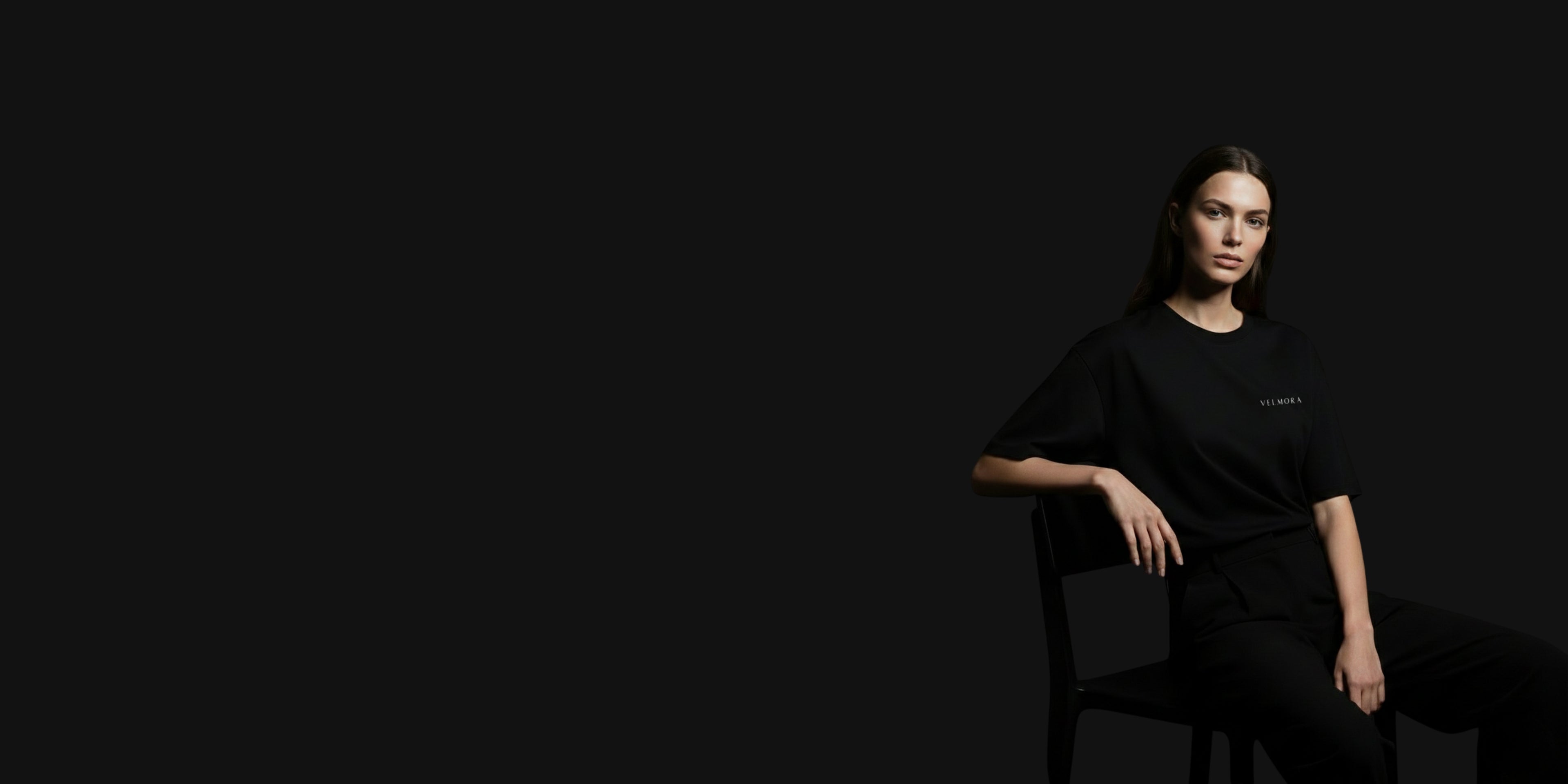 Model wearing premium black minimalist streetwear t-shirt by Velmora